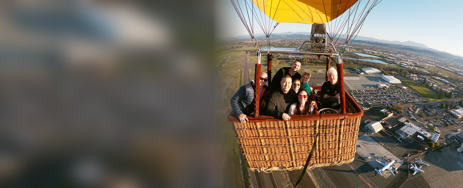 Our pilot and a full basket of guests smiling on a sunrise flight above Santa Rosa
